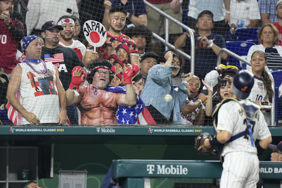 Japan catcher Yuhei Nakamura (27) chases a foul ball during third inning of a World Baseball Classic championship game against the United States, Tuesday, March 21, 2023, in Miami. (AP Photo/Wilfredo Lee)