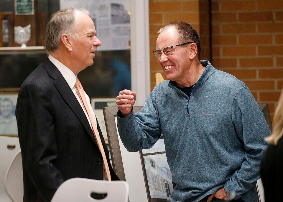 Ashland City School Superintendent Doug Marrah talks with Tom Lavinder during a Dec. 12 reception honoring Marrah as he retires.