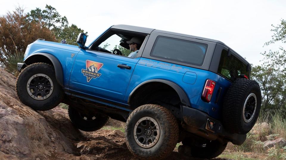 a blue jeep on a dirt road