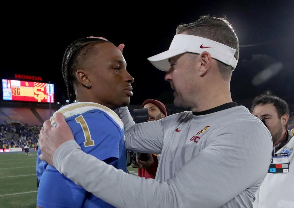 USC coach Lincoln Riley talks with UCLA quarterback Dorian Thompson-Robinson after the Trojans' win Nov. 19, 2022.