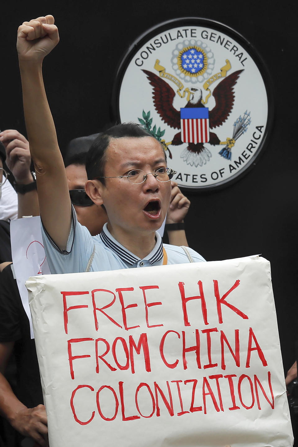 A protester chants slogans outside the U.S. Consulate in Hong Kong, Wednesday, June 26, 2019. Hong Kong activists opposed to contentious extradition legislation on Wednesday called on leaders of the U.S., the European Union and others to raise the issue with Chinese President Xi Jinping at this week's G-20 summit in Japan. (AP Photo/Kin Cheung)