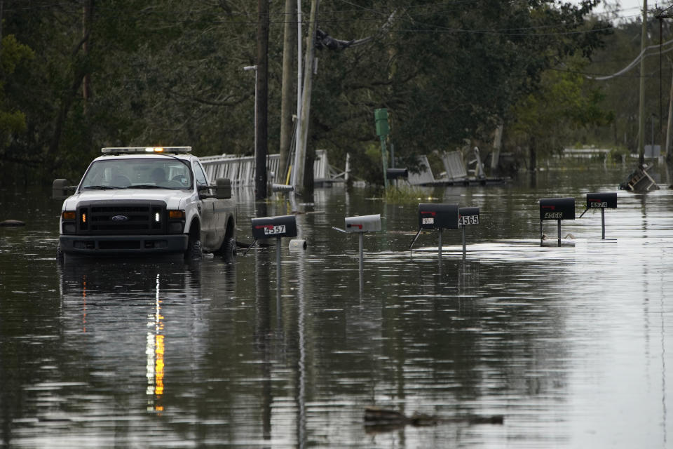 Mailboxes line a flooded street in the aftermath of Hurricane Ida, Wednesday, Sept. 1, 2021, in Lafitte, La. Following Hurricane Ida, mutual aid networks sprang into action to supplement the more established relief services from federal and local governments, and charities. (AP Photo/John Locher)