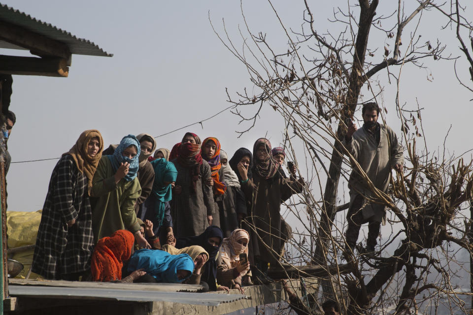 Kashmiri villagers watch the funeral procession of a local rebel Muzamil Ahmed Dar in Rahmoo village south of Srinagar, Indian controlled Kashmir, Saturday, Dec. 29, 2018. Anti-India protests and clashes erupted in disputed Kashmir on Saturday after a gunbattle between militants and government forces killed four rebels, police and residents said. (AP Photo/ Dar Yasin)