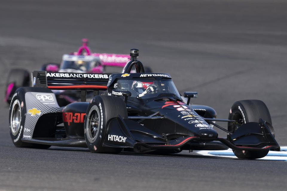 Josef Newgarden drives into a turn during a practice session for the IndyCar Grand Prix auto race at Indianapolis Motor Speedway, Friday, May 10, 2024, in Indianapolis. (AP Photo/Darron Cummings)