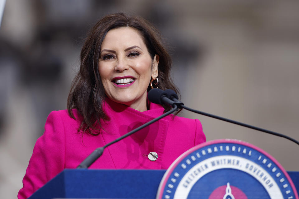 FILE- Michigan Gov. Gretchen Whitmer addresses the crowd during inauguration ceremonies on Sunday, Jan. 1, 2023, outside the state Capitol in Lansing, Mich. Whitmer will travel to Europe next week for a five-day trip to promote the state's recent economic developments and with hopes of attracting new businesses in the automotive and clean energy industries. (AP Photo/Al Goldis, File)