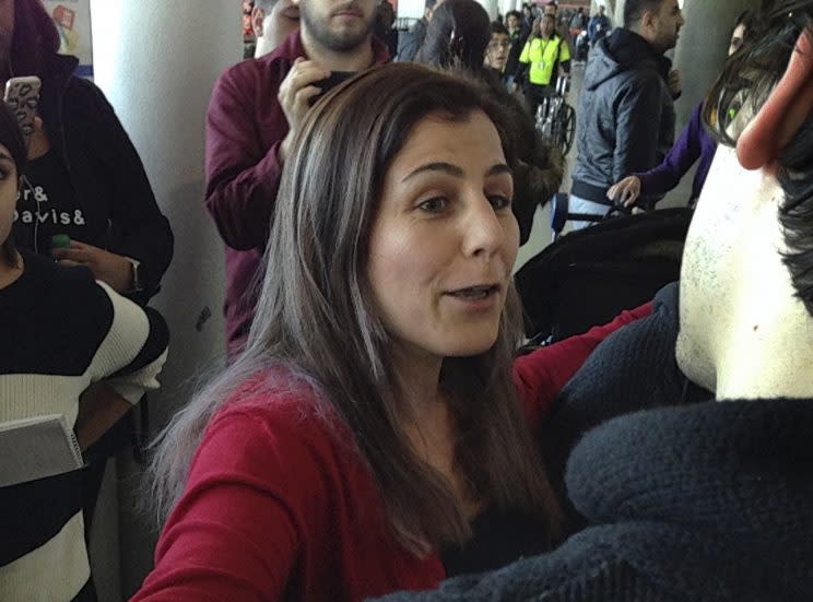 Vahideh Rasekhi, an Iranian doctoral student at Stony Brook University, greets friends and family as she is released from detention at John F. Kennedy International Airport in New York, Sunday, Jan. 29, 2017. (AP Photo/Seth Wenig)