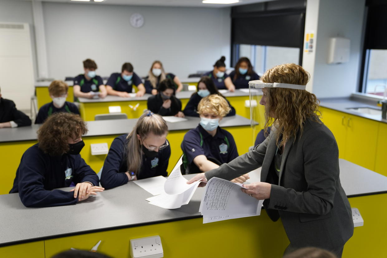 Children and teacher in Year 11 wearing facemasks during lesson at Our Lady and St Bede Catholic Academy in Stockton-on-Tees in County Durham, as pupils in England return to school for the first time in two months as part of the first stage of lockdown easing. Picture date: Monday March 8, 2021.