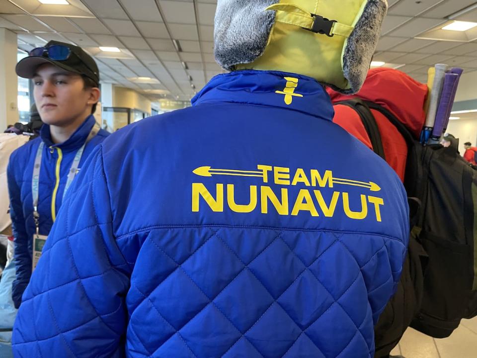 A member of Team Nunavut shows off his team jacket.