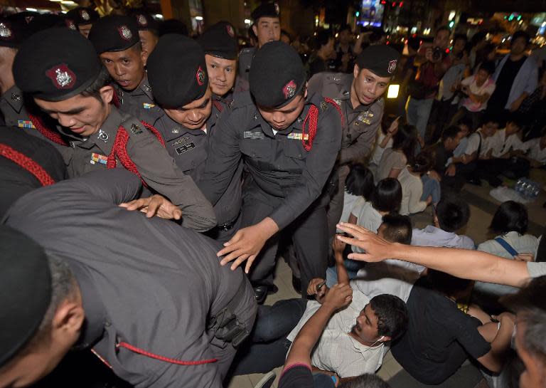 Thai police arrest students for demonstrating at a shopping mall in Bangkok on May 22, 2015