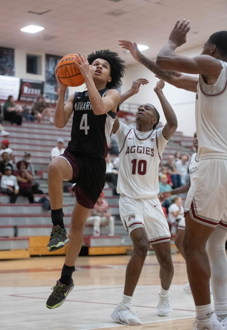 Jonah Forrest (4) takes it to the hoop during the Navarre vs Tate boys basketball game at Tate High School on Friday, Jan. 12, 2024.