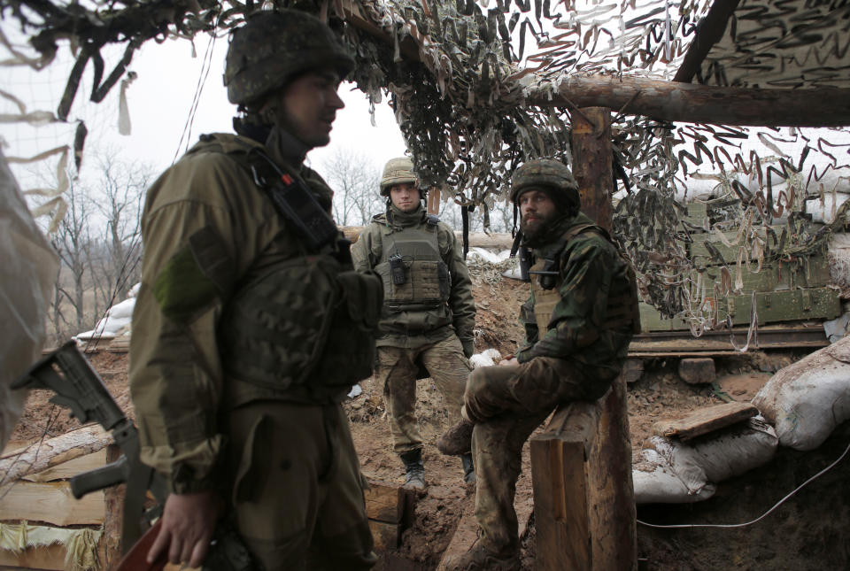 Ukrainian soldiers in a trench on the front line near the town of Novoluhanske in the Donetsk region, Ukraine, Monday, Dec. 9, 2019. A long-awaited summit in Paris on Monday aims to find a way to end the war in eastern Ukraine, a conflict that after five years and 14,000 lives lost has emboldened the Kremlin and reshaped European geopolitics. (AP Photo/Vitali Komar)