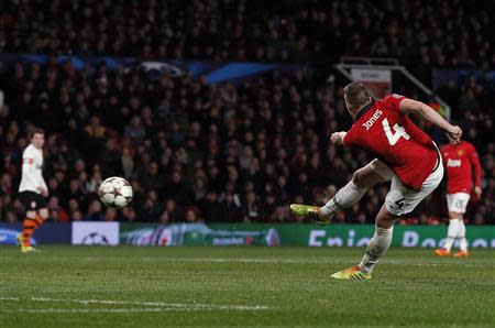 Manchester United's Phil Jones (R) shoots to score during their Champions League soccer match against Shakhtar Donetsk at Old Trafford in Manchester, northern England, December 10, 2013. REUTERS/Phil Noble