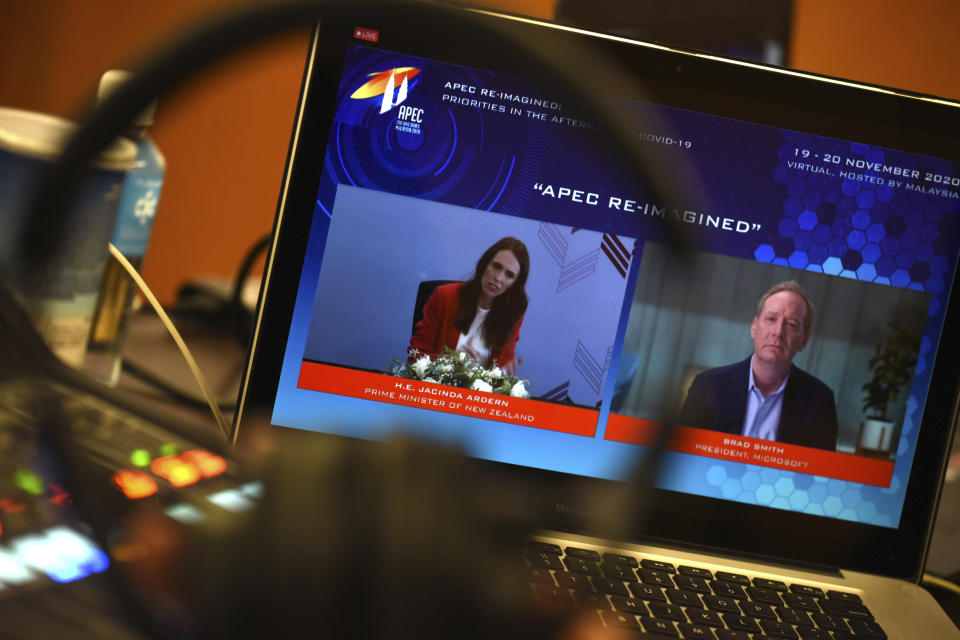 In this photo released by Malaysia Department of Information, a screen shows New Zealand's Prime Minister Jacinda Ardern, left, and Microsoft President Brad Smith speak via virtual meeting during the APEC CEO Dialogues 2020, ahead of the Asia-Pacific Economic Cooperation (APEC) leaders' summit in Kuala Lumpur, Malaysia, Friday, Nov. 20, 2020. (Fandy Azlan/Malaysia Department of Information via AP)
