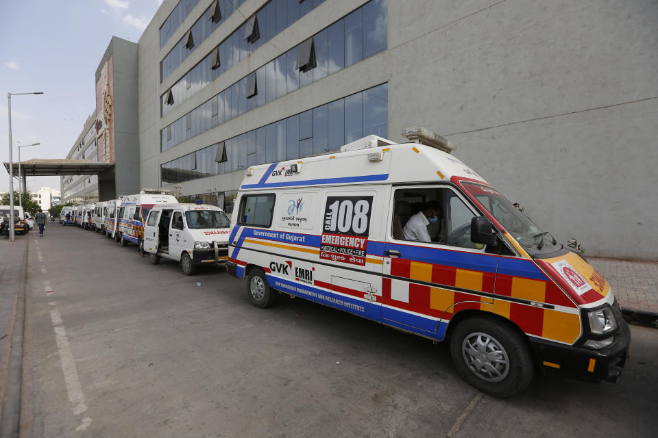 Ambulances carrying COVID-19 patients queue up waiting for their turn to be attended at a dedicated COVID-19 government hospital in Ahmedabad, India, Saturday, April 17, 2021. India's health system is collapsing under the worst surge in coronavirus infections that it has seen so far. Medical oxygen is scarce. Intensive care units are full. Nearly all ventilators are in use, and the dead are piling up at crematoriums and graveyards. Such tragedies are familiar from surges in other parts of the world — but were largely unknown in India. (AP Photo/Ajit Solanki)