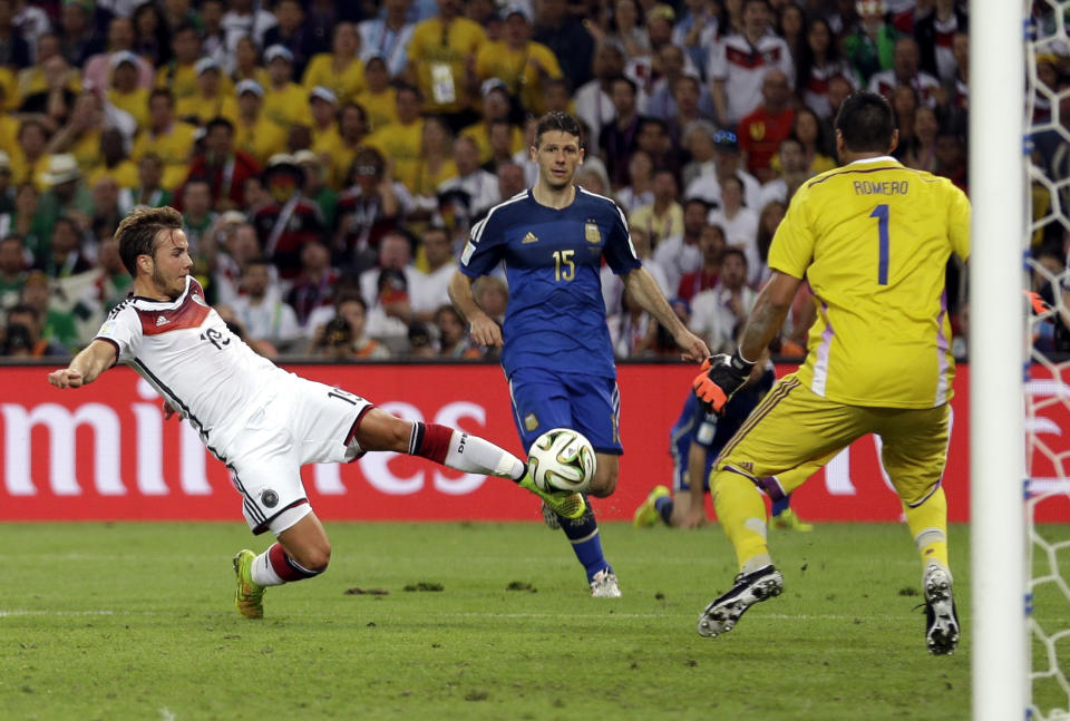 FILE - Germany's Mario Goetze scores his side's first goal in extra time against Argentina's goalkeeper Sergio Romero during the World Cup final soccer match at the Maracana Stadium in Rio de Janeiro, Brazil, Sunday, July 13, 2014. (AP Photo/Natacha Pisarenko, File)