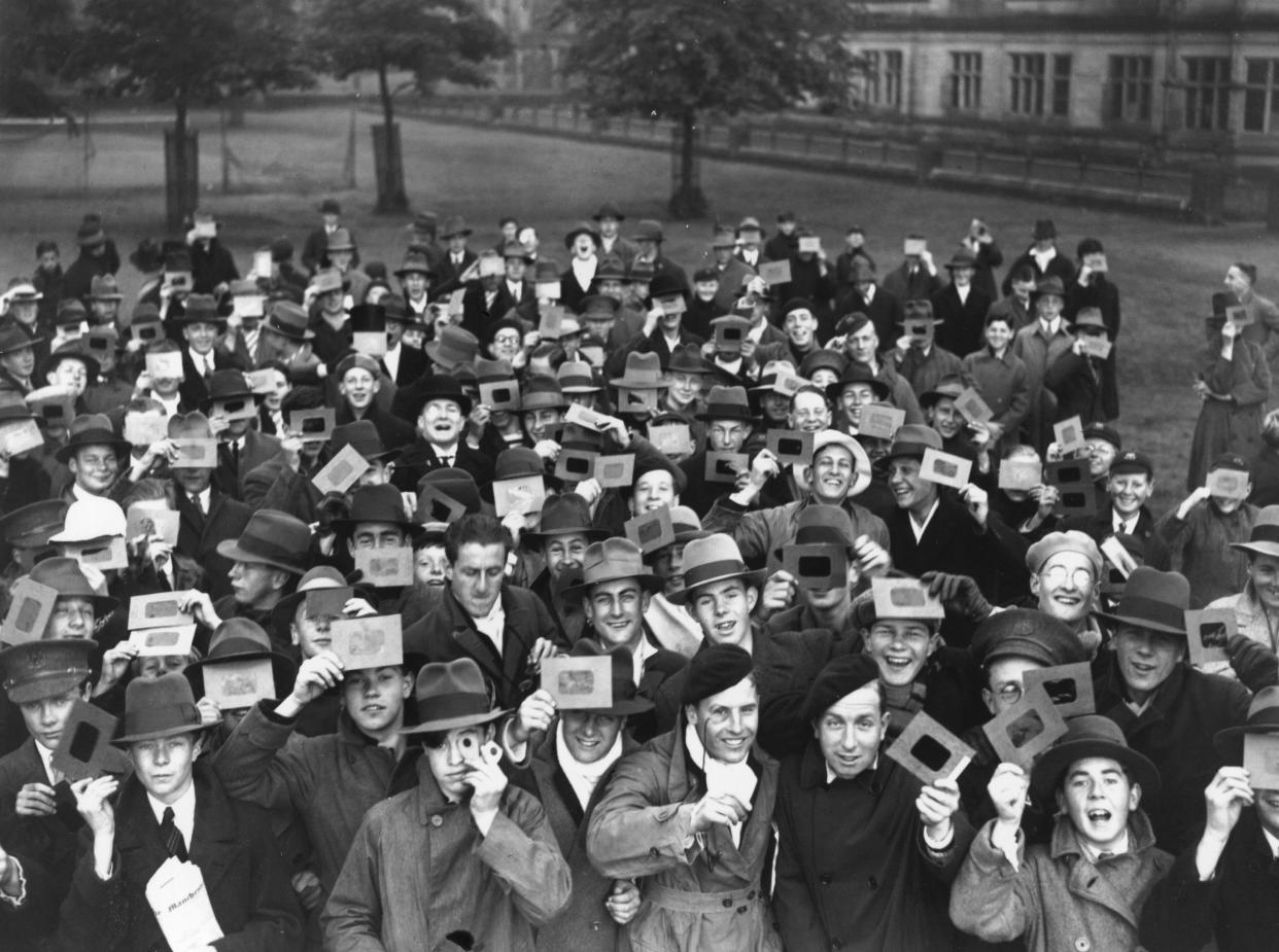 1927: A large crowd of people observe a solar eclipse from the grounds of Stonyhurst College in Lancashire, England.