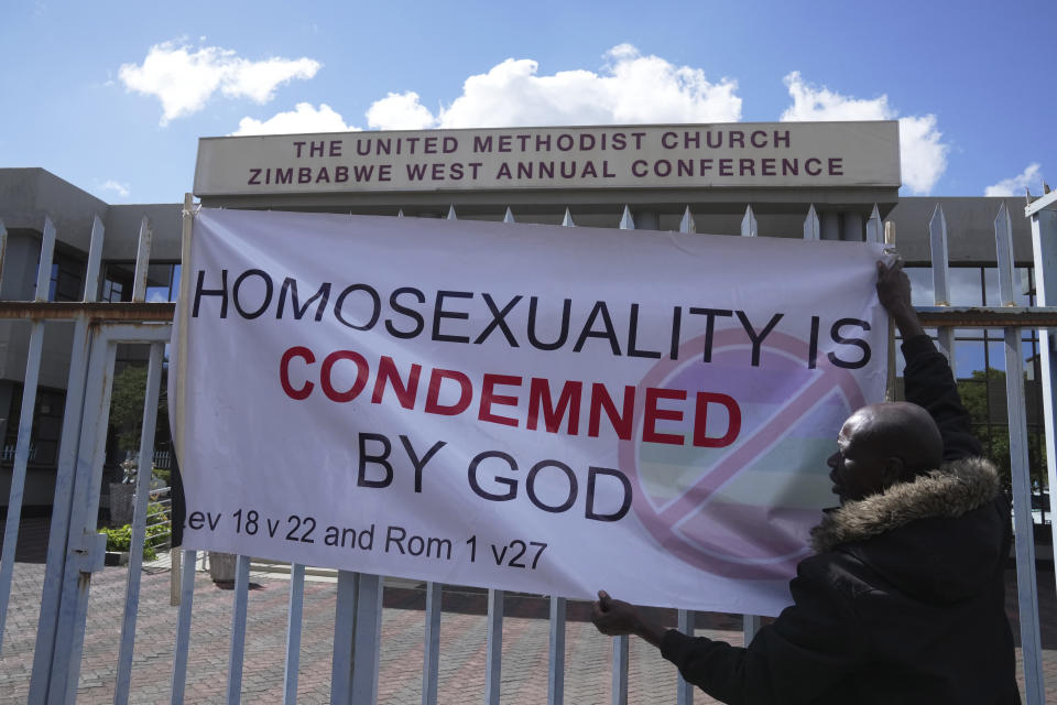 A member the United Methodist Church in Zimbabwe displays a placard while holding a protest at the church premises in Harare, Thursday, May 30, 2024. The protests denouncing homosexuality and the departure of the church from the scriptures and doctrine, come barely a month after the United Methodist Church Worldwide General Conference held in North Carolina, US repealed their church's longstanding ban on LGBTQ clergy, removing a rule forbidding "self-avowed practising homosexuals" from being ordained or appointed as ministers. (AP Photo/Tsvangirayi Mukwazhi)