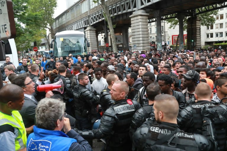 Police evict between 1,200 and 1,400 migrants from a makeshift camp in Paris on July 22, 2016