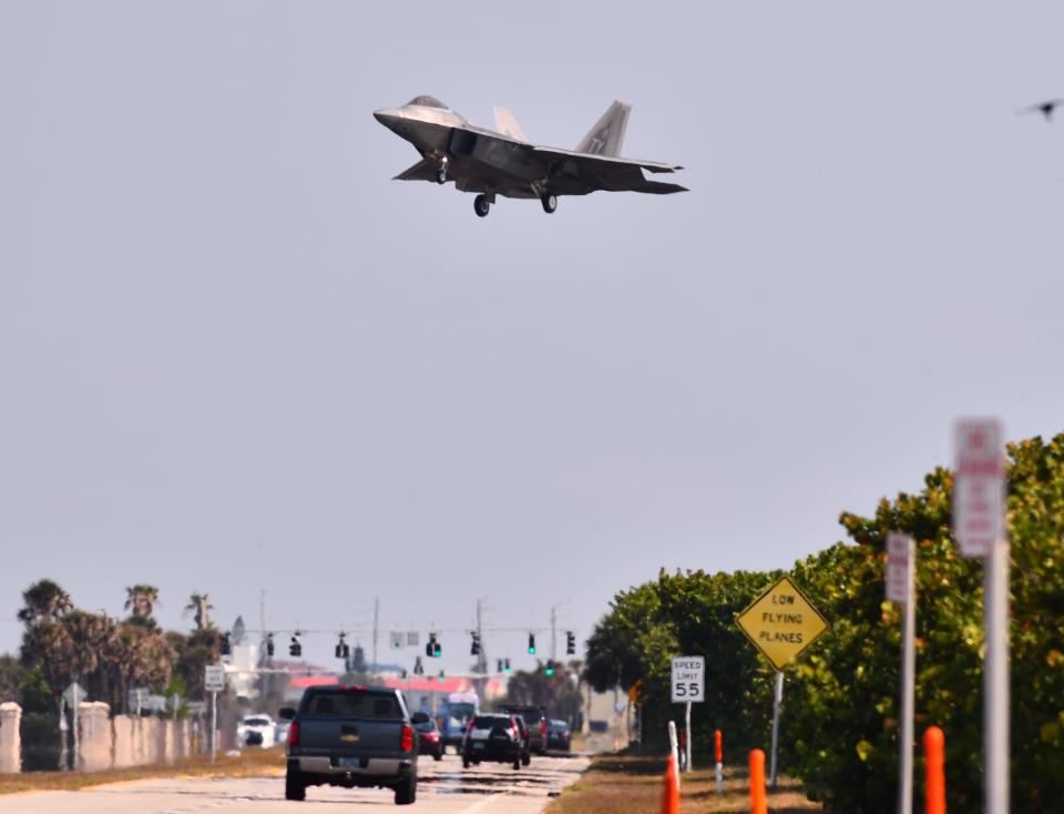 A U.S. Air Force F-22 Raptor flies above State Road A1A outside Patrick Space Force Base on Thursday morning.