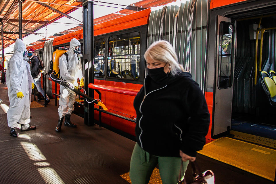 Military personnel from the Brazilian Armed Forces sanitize a bus at the Santa Candida bus terminal to combat the spread of the the novel coronavirus, COVID-19, in Curitiba, Parana State, Brazil, on August 10, 2020. - The pandemic has killed at least 731,518 people worldwide, 101,049 of them in Brazil, since it surfaced in China late last year, according to a tally from official sources compiled by AFP at 1100 GMT on Monday. (Photo by Daniel CASTELLANO / AFP) (Photo by DANIEL CASTELLANO/AFP via Getty Images)