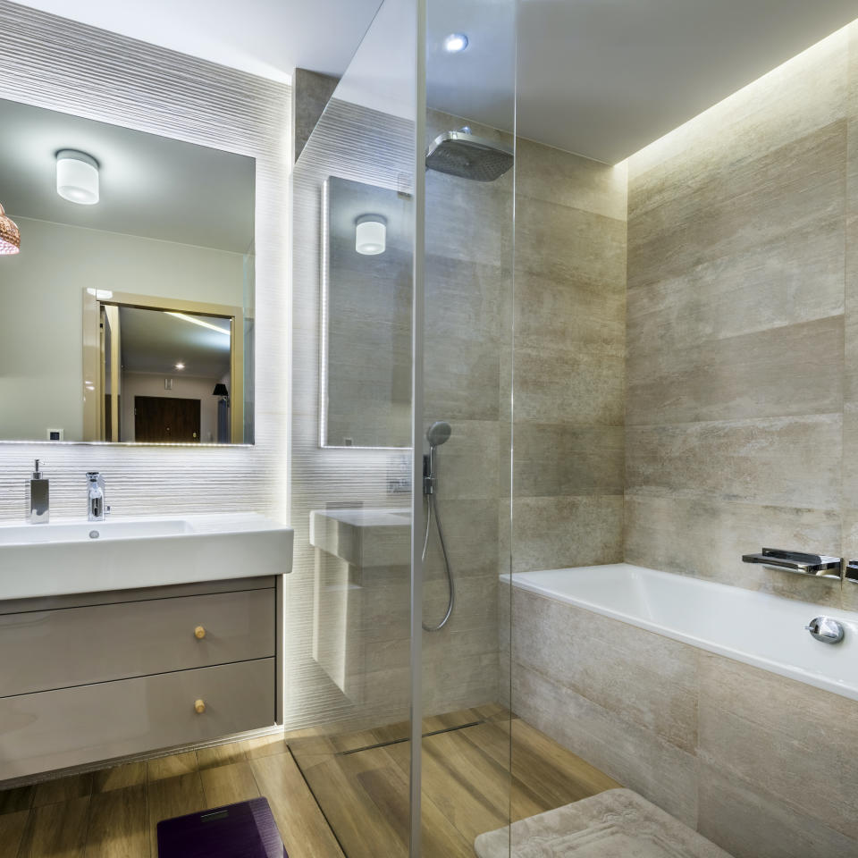 Modern bathroom with wooden floor in stylish apartment