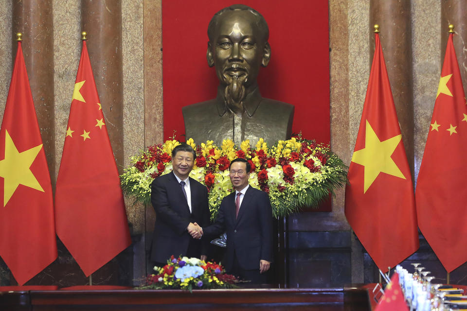 Vietnamese President Vo Van Thuong, right, and Chinese President Xi Jinping, left, shake hands at the Presidential Palace in Hanoi, Vietnam Wednesday, Dec. 13, 2023. (Luong Thai Linh/Pool Photo via AP)