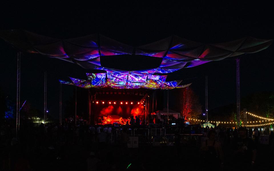 A large canopy with visuals hangs above the stage area of Desert Daze on Nov. 12, 2021 at Lake Perris State Recreation Area in Perris during Deap Vally's performance.