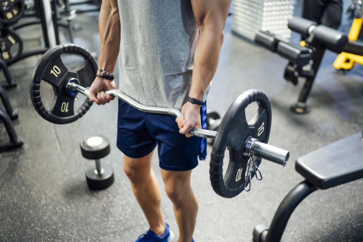 strong man in gym catching weights