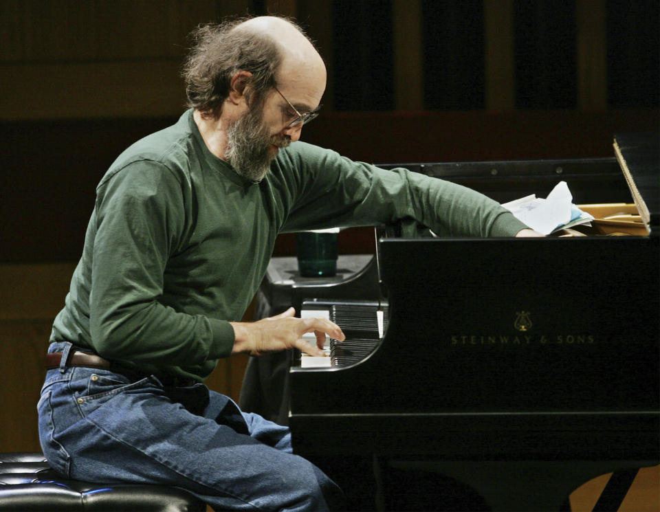 FILE - George Winston makes an adjustment on his piano during a sound check before his performance at the Cerritos Center for the Performing Arts in Cerritos, Calif., on Nov. 4, 2004. Winston, the Grammy-winning pianist who blended jazz, classical, folk and other stylings on such million-selling albums as “Autumn,” “Winter Into Spring” and “December,” died Sunday, June 4, 2023, after a 10-year battle with cancer. He was 73. (AP Photo/Reed Saxon, File)