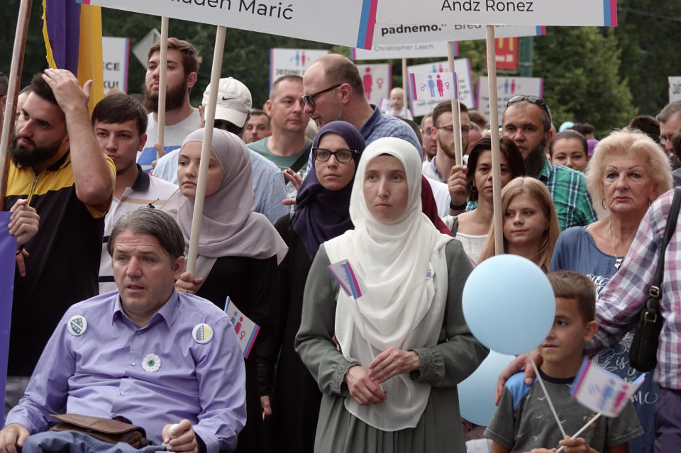 Holding banners and balloons, participants march in what they said was a gathering designed to promote traditional family values in Sarajevo, Bosnia, Saturday, Sept. 7, 2019. Several hundred people have marched in Bosnia's capital Sarajevo to express their disapproval of the Balkan country's first ever LGBT pride parade scheduled for Sunday. (AP Photo/Eldar Emric)