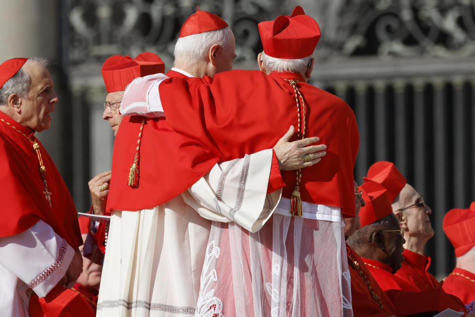 Cardinals greet each other as they wait for a consistory to start in St. Peter's Square at The Vatican where Pope Francis will create 21 new cardinals, Saturday, Sept. 30, 2023. (AP Photo/Riccardo De Luca)