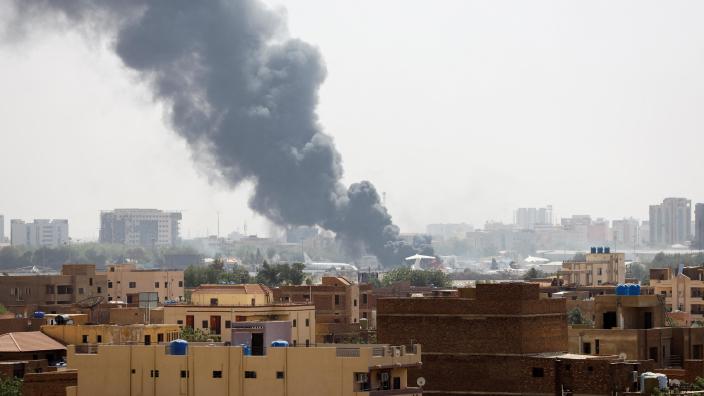 Smoke rises from burning aircraft inside Khartoum Airport during clashes 