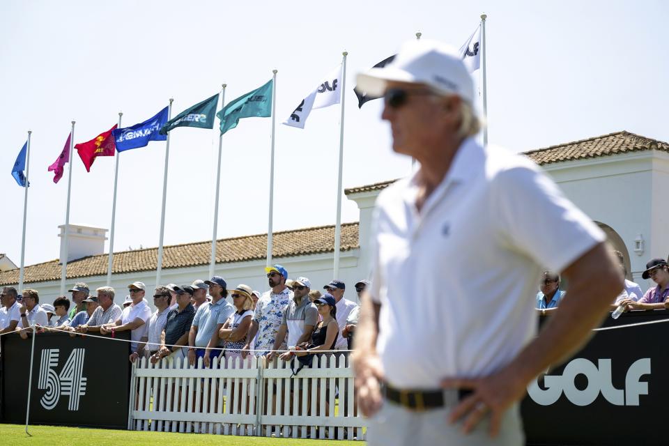 Fans watch as LIV Golf CEO Greg Norman looks on from the driving range before the first round of an LIV golf tournament at the Real Club Valderrama in San Roque, Spain, Friday, June 30, 2023. (Matthew Harris/LIV Golf via AP)