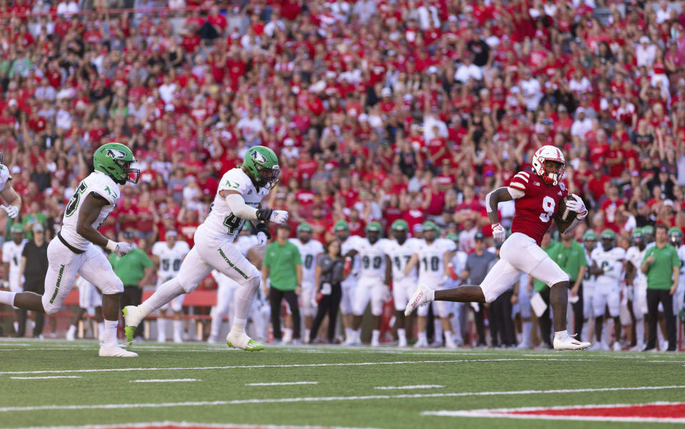 Nebraska's Ajay Allen (9) runs for a touchdown as North Dakota's Aaron Cooper, left, and Jack Baretz trail during the second half of an NCAA college football game Saturday, Sept. 3, 2022, in Lincoln, Neb. Nebraska won 38-17. (AP Photo/Rebecca S. Gratz)