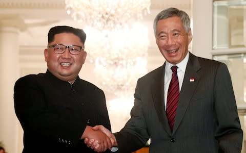 North Korea's leader Kim Jong-un shakes hands with Lee Hsien Loong, Singapore's prime minister  - Credit: Reuters