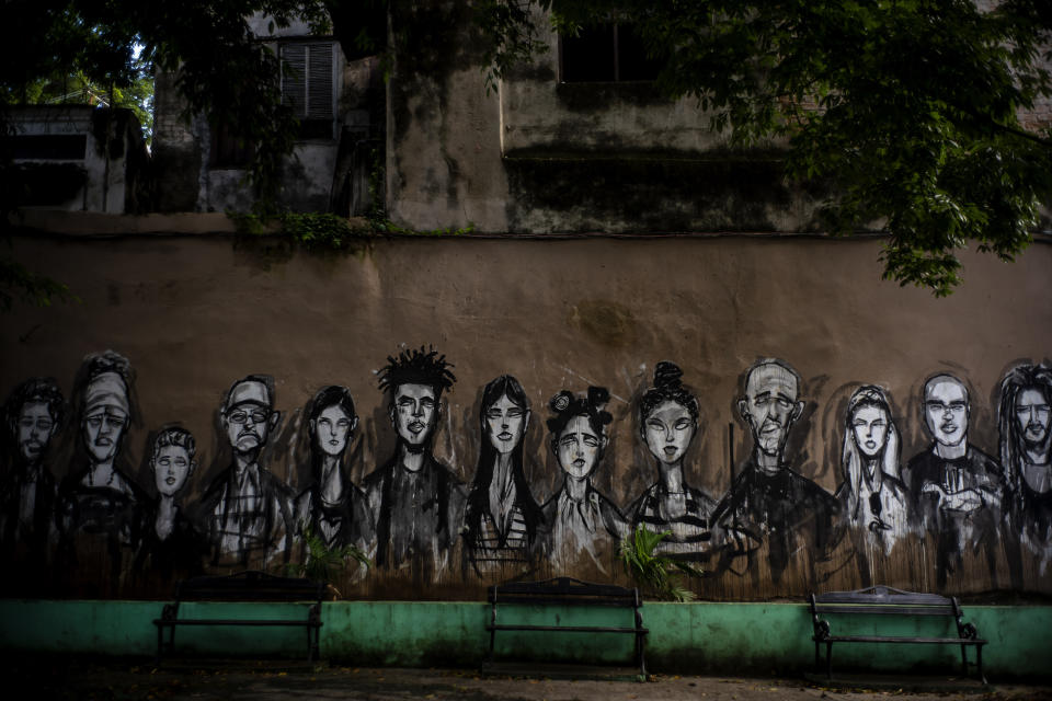 In this Nov. 10, 2019 photo, a wall is covered by a mural of faces, representing local residents, in a plaza in Old Havana, Cuba. The city will celebrate its 500th anniversary on Nov. 16. (AP Photo/Ramon Espinosa)