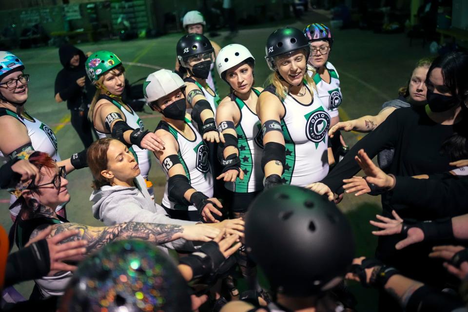 Ohio Roller Derby team members huddle after a scrimmage.