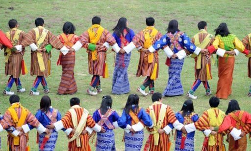 Dancers perform at the main stadium in Thimphu on October 15, 2011. The decline in polygamy is linked to changing attitudes in Bhutan, a tiny Himalayan nation sandwiched between India and China that has resisted outside influence for centuries