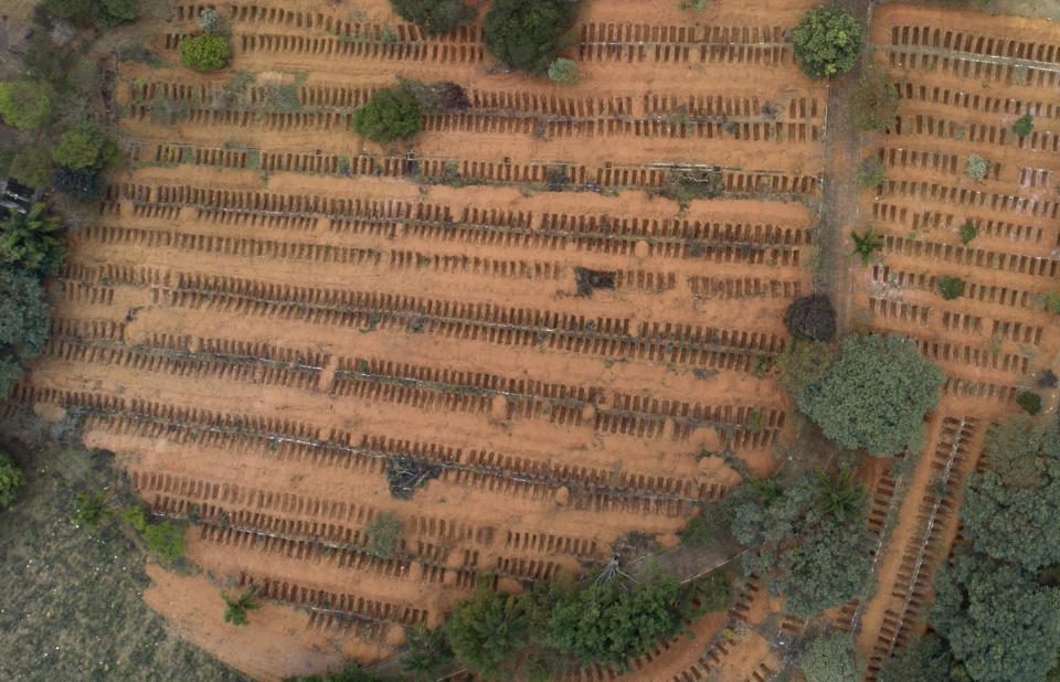 Newly dug, empty graves fill the Sao Luiz cemetery where COVID-19 victims will be buried in Sao Paulo, Brazil, Thursday, June 4, 2020. (AP Photo/Andre Penner)