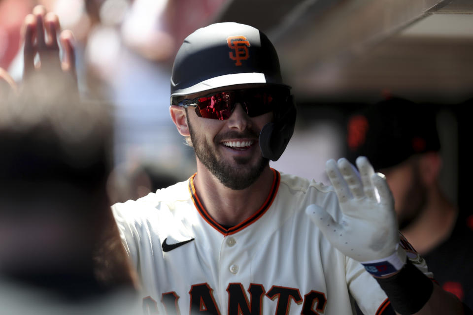 San Francisco Giants' Kris Bryant is congratulated by teammates after hitting a home run against the Houston Astros during the third inning of a baseball game in San Francisco, Sunday, Aug. 1, 2021. (AP Photo/Jed Jacobsohn)