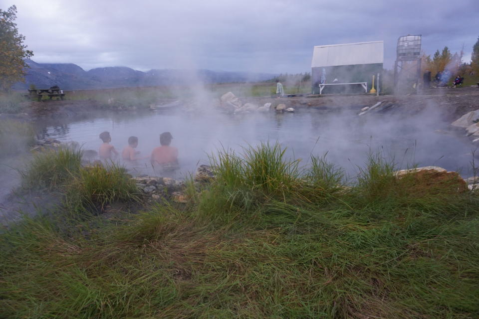 Three boys soak in a pool at Pilgrim Hot Springs on Sept. 4, 2021. The historic area is a popular recreation destination for Nome residents. (Photo by Yereth Rosen/Alaska Beacon)