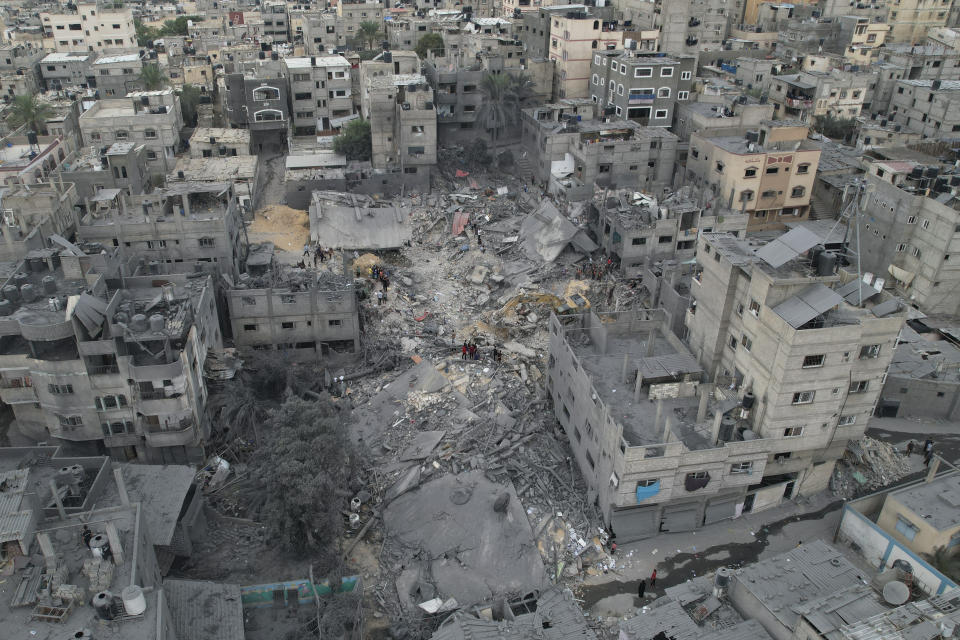 Palestinians inspect the rubble of a house after it was struck by an Israeli airstrike in Khan Younis refugee camp, Gaza Strip, Friday, Oct.27, 2023. (AP Photo/Hatem Moussa)