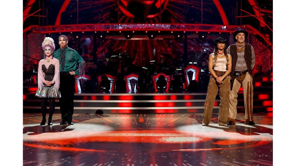 four people standing on dance floor