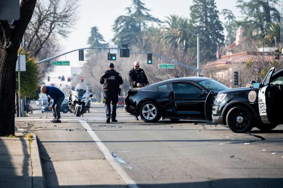 Police respond to the scene of a collision involving a vehicle and train on M Street in Merced, Calif., on Wednesday, Feb. 1, 2023. According to police, the 65-year-old driver was not injured when the vehicle rolled forward and collided with the passing freight train.