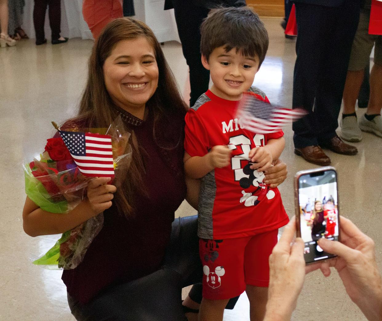 Melissa Baker of Davenport, an immigrant from Colombia, poses with her son, Adrian, after participating in a naturalization  ceremony Friday morning at the Polk History Center in Bartow. More than 60 immigrants gained citizenship in two ceremonies.
