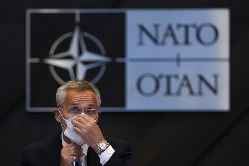 NATO Secretary General Jens Stoltenberg adjusts his protective face mask during a NATO Foreign Ministers video meeting following developments in Afghanistan at the NATO headquarters in Brussels, Friday, Aug. 20, 2021. (AP Photo/Francisco Seco, Pool)
