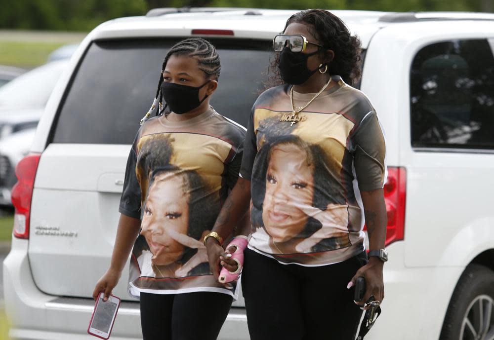 Mourners are seen wearing shirts with Ma’Khia Bryant’s picture as they arrive for the funeral for the 16-year-old at the First Church of God in Columbus, Ohio, Friday, April 30, 2021. (AP Photo/Paul Vernon)