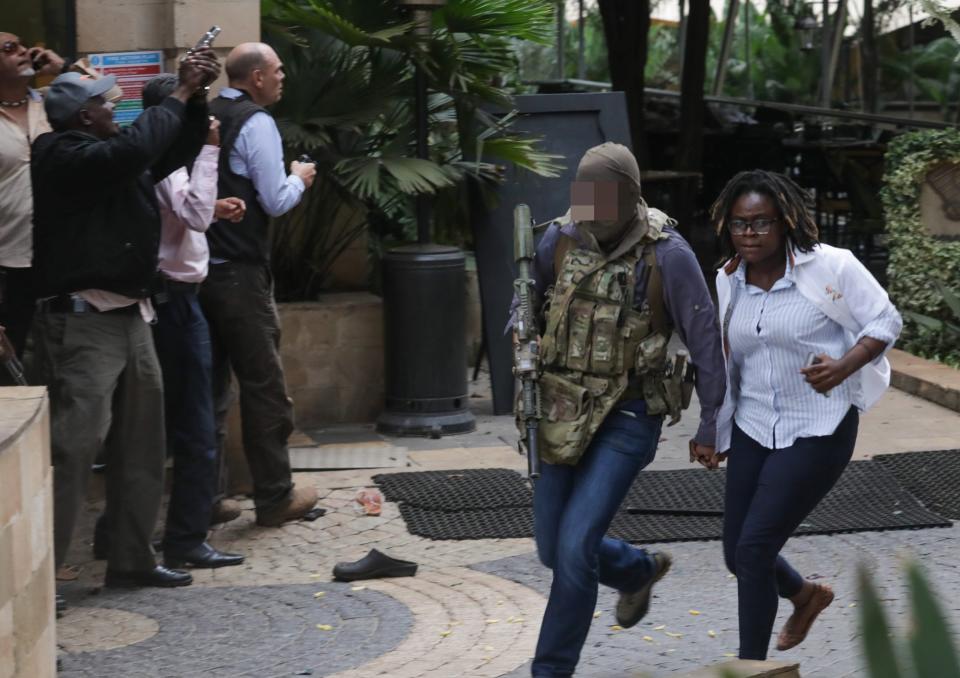 Picutres showed a man helping victims flee (EPA)