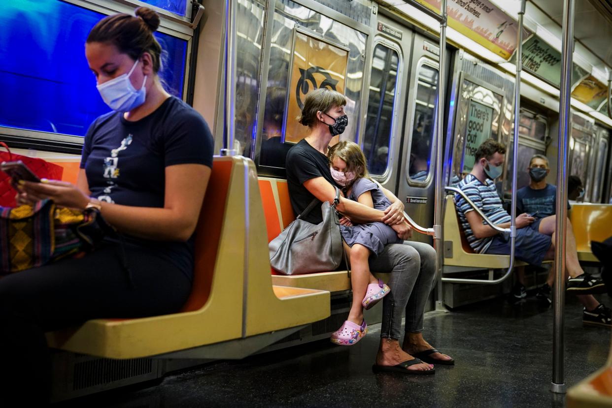 New York City subway passengers wear protective masks due to COVID-19 concerns on Aug. 17, 2020.