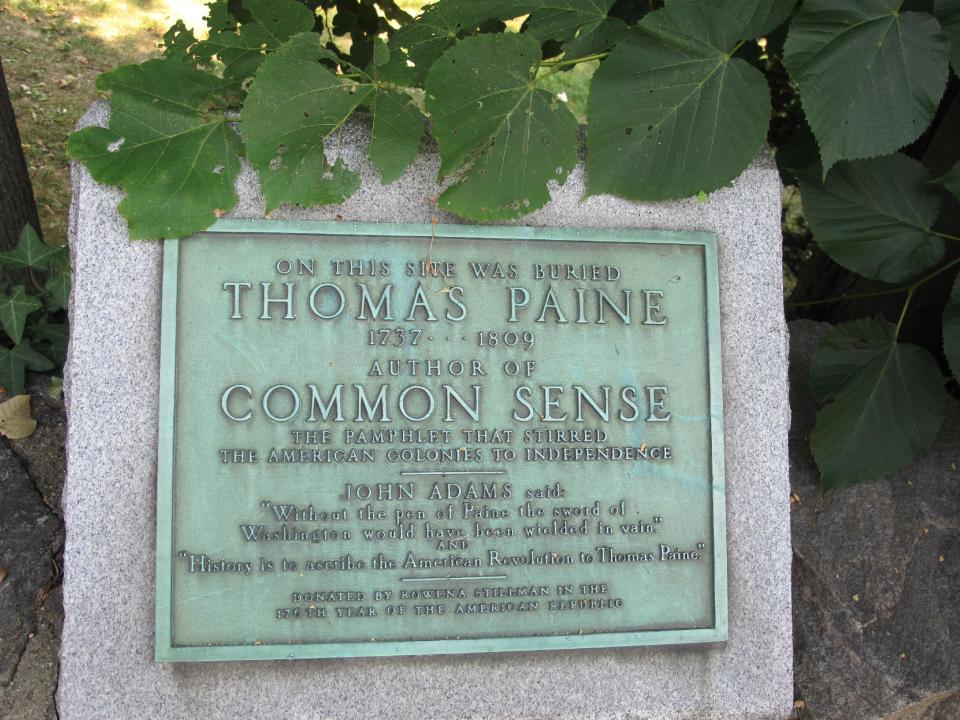 In this Tuesday, Aug. 20, 2013 photo, a plaque marks the burial site of Thomas Paine in New Rochelle, N.Y. A once-endangered collection of about 300 Paine-related pieces is the cornerstone of a new Institute for Thomas Paine Studies at nearby Iona College. (AP Photo/Jim Fitzgerald)